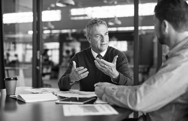 An attorney talking with a colleague in an office